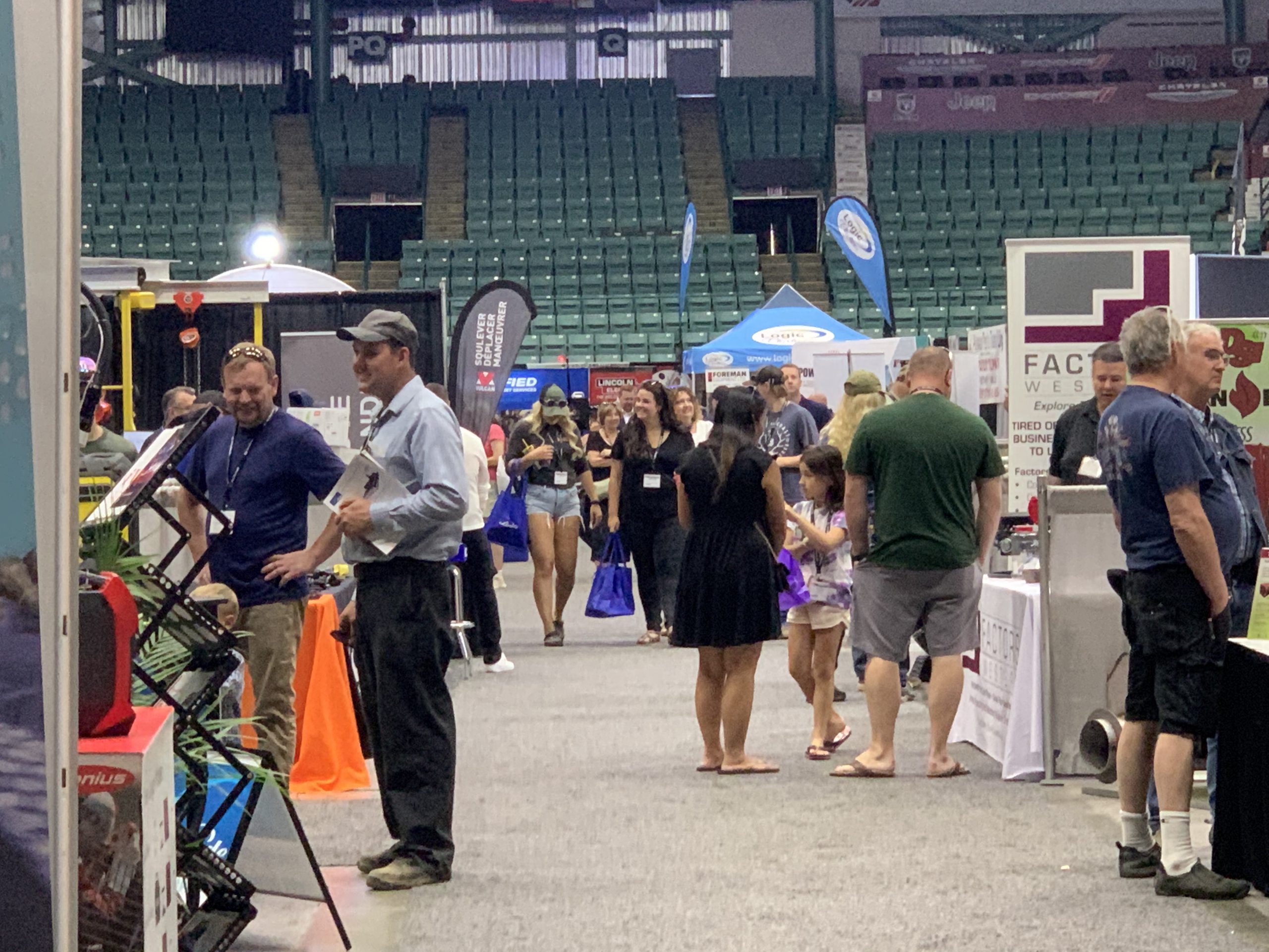 People talking at a trade show for heavy equipment